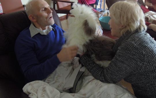 Joyce Simard and her sheepdog puppet interacting with a man in Iceland