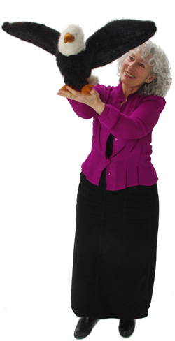 Marge Schneider holding an eagle puppet