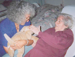 Marge Schneider helping a client with a dog puppet