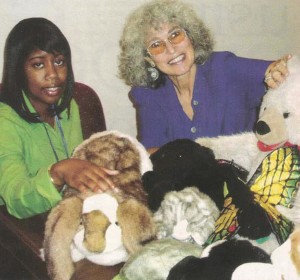 Marge Schneider and Kinsha Williams-Davis, RN pose with puppets.